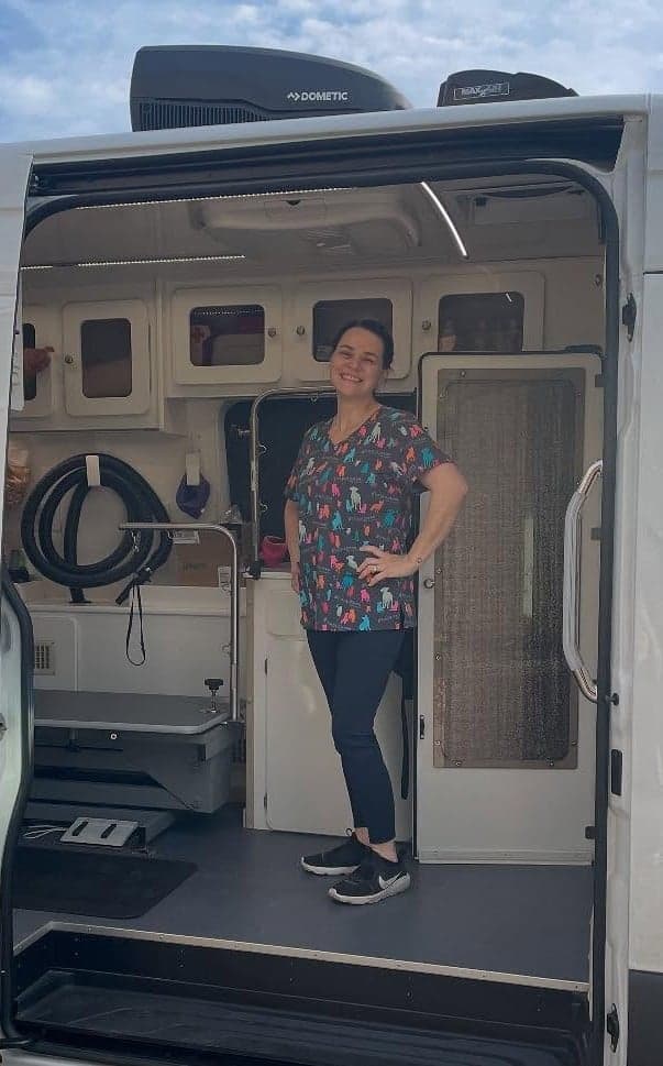 Kendra in the doorway of her Perfect Paws Pet Spa mobile grooming van